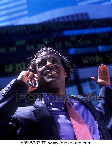 Office worker with telephone, Below stock market ticker display. View Large Photo Image Stock Photo - Office worker with telephone, Below stock market ticker display.. Fotosearch