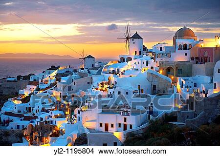 Picture - Oia Ia Santorini - Windmills and town at sunset, Greek Cyclades islands.. Fotosearch