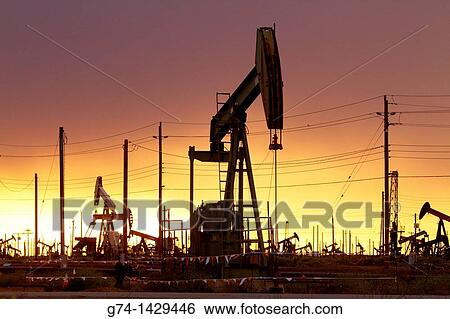 Oil Pumps at work in oil and gas field USA View Large Photo Image Stock Photograph - Oil Pumps at work in oil and gas field USA. Fotosearch