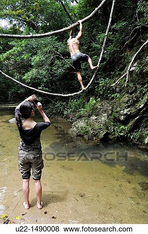 Okinawa (Japan): friends playing by the Ta waterfall View Large Photo Image Stock Photo - Okinawa (Japan): friends playing by the Ta waterfall. Fotosearch