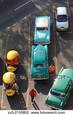 Old american cars and Coco Taxis parked at the street, Havana, Cuba, West Indies, Central America. View Large Photo Image Stock Image - Old american cars and Coco Taxis parked at the street, Havana, Cuba, West Indies, Central America.. Fotosearch