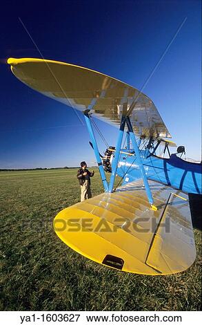 Old american trainer biplane Boeing PT-17 Kaydet / Stearman model 75 and pilot checking his aircraft before flight, France View Large Photo Image Stock Photo - Old american trainer biplane Boeing PT-17 Kaydet / Stearman model 75 and pilot checking his aircraft before flight, France. Fotosearch