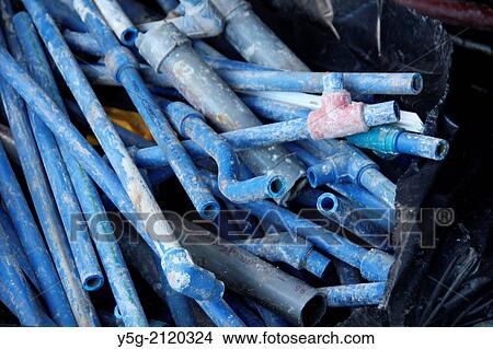 old blue plastic tubes on a building site View Large Photo Image Picture - old blue plastic tubes on a building site. Fotosearch