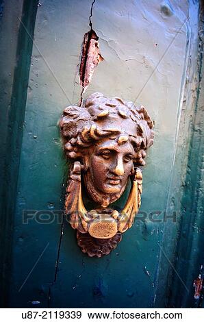 Stock Photo - Old Brass Door Knocker with Figure.. Fotosearch