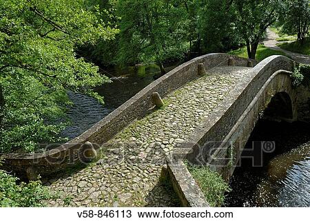 Stock Image - Old bridge over the Cure river, Pierre-Perthuis, Parc Naturel Regional du Morvan, Yonne, France. Fotosearch