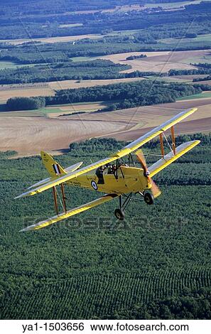 Old British trainer biplane De Havilland DH-82a Tiger Moth in flight over France View Large Photo Image Stock Photograph - Old British trainer biplane De Havilland DH-82a Tiger Moth in flight over France. Fotosearch
