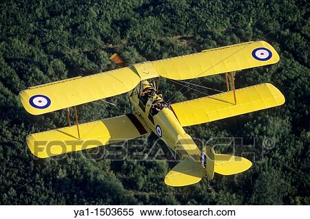 Old British trainer biplane De Havilland DH-82a Tiger Moth in flight over France View Large Photo Image Stock Photography - Old British trainer biplane De Havilland DH-82a Tiger Moth in flight over France. Fotosearch