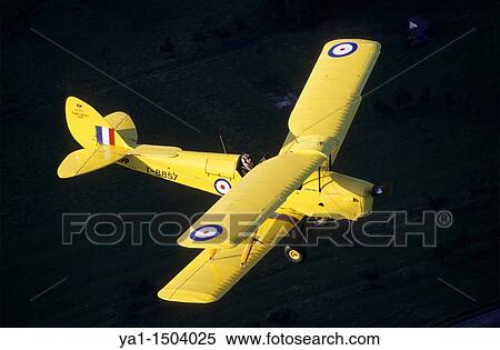 Old British trainer biplane De Havilland DH-82a Tiger Moth in flight over France View Large Photo Image Stock Photography - Old British trainer biplane De Havilland DH-82a Tiger Moth in flight over France. Fotosearch