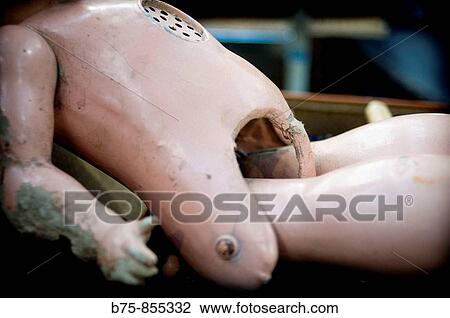 Stock Image - Old broken doll. Fotosearch