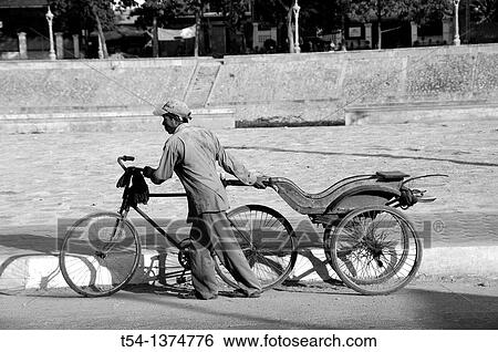 Old Cambodian man pushes bicycle rickshaw View Large Photo Image Stock Photograph - Old Cambodian man pushes bicycle rickshaw. Fotosearch