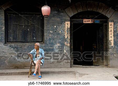 Old Chinese man sitting in of the traditional Streets of Pingyao, Shaanxi Province China View Large Photo Image Stock Photography - Old Chinese man sitting in of the traditional Streets of Pingyao, Shaanxi Province China. Fotosearch