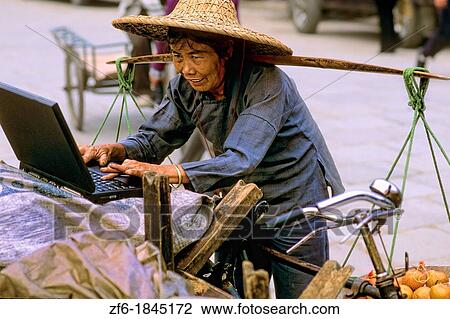 Old Chinese woman vendor on laptop in Guangzhou China. View Large Photo Image Stock Image - Old Chinese woman vendor on laptop in Guangzhou China.. Fotosearch