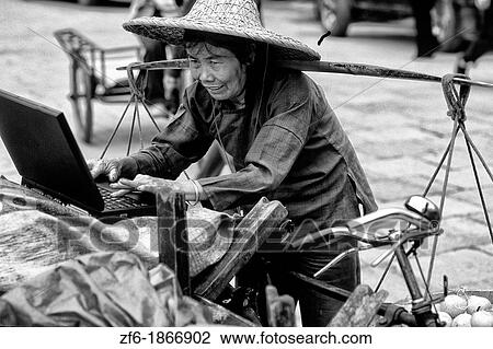 Old Chinese woman vendor on laptop in Yangshou China View Large Photo Image Stock Image - Old Chinese woman vendor on laptop in Yangshou China. Fotosearch