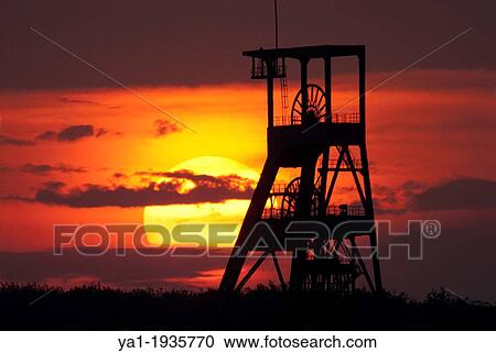 Stock Image - Old coal mine pit on Sunset, Puit Simon 2 HBL, Forbach, Moselle, Lorraine, France. Fotosearch