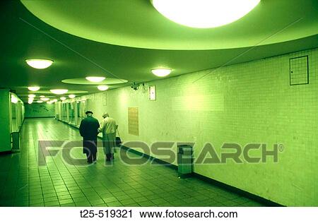 Stock Image - Old Couple leaving Underground Station, Kurf? rstendamm, Berlin, Germany. Fotosearch