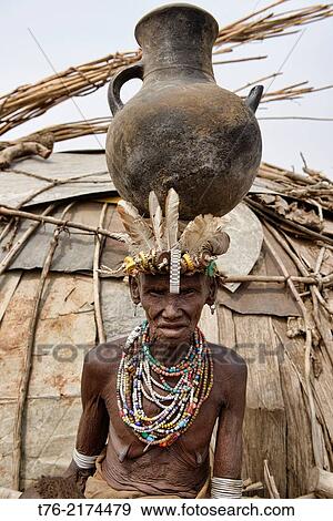 old Dassanech woman in front of her hut in the Lower Omo Valley of Ethiopia. View Large Photo Image Stock Photo - old Dassanech woman in front of her hut in the Lower Omo Valley of Ethiopia.. Fotosearch
