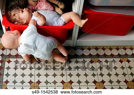 Stock Photo - Old dolls on a shelf. Fotosearch