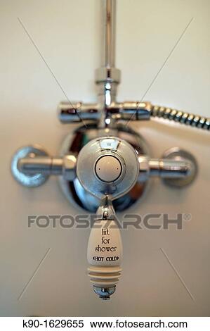 Old english water tap of a shower indicating hot and cold water, pointing to the middle View Large Photo Image Stock Photography - Old english water tap of a shower indicating hot and cold water, pointing to the middle. Fotosearch