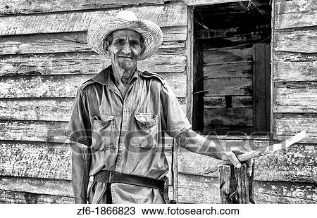 Old farmer man cutting sugar cane in front of old green house near Trinidad Cuba View Large Photo Image Stock Image - Old farmer man cutting sugar cane in front of old green house near Trinidad Cuba. Fotosearch