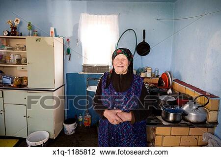 Old farmer outside her old house. She now lives in a newer farmhouse. Gmina Przylek, Zwolen county, Poland. View Large Photo Image Stock Image - Old farmer outside her old house. She now lives in a newer farmhouse. Gmina Przylek, Zwolen county, Poland.. Fotosearch