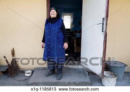 Old farmer outside her old house. She now lives in a newer farmhouse. Gmina Przylek, Zwolen county, Poland. View Large Photo Image Stock Image - Old farmer outside her old house. She now lives in a newer farmhouse. Gmina Przylek, Zwolen county, Poland.. Fotosearch