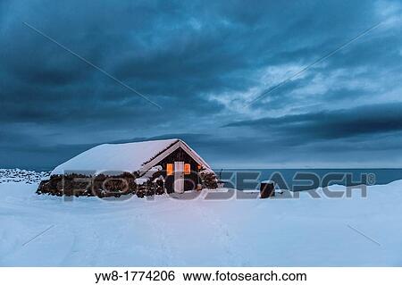 Stock Photograph - Old farmhouse with turfed roof in the winter, Skagafjordur, Iceland. Fotosearch