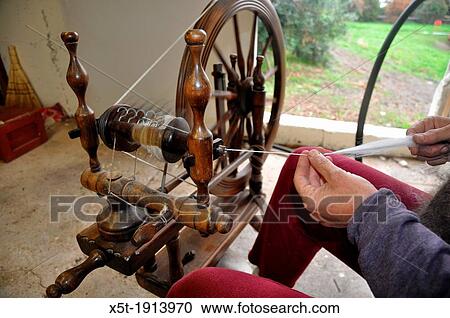 Stock Image - Old Fashioned manual wool spinning wheel. Fotosearch