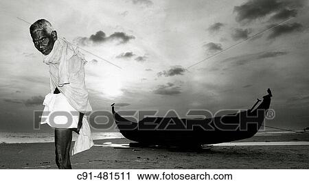 Stock Image - Old fisherman and boat. India. Fotosearch