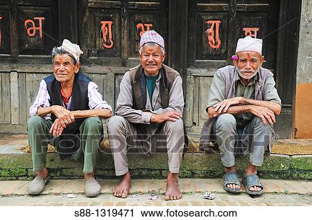 Stock Image - Old friends sit together, Bhaktapur Bhadgaon Kathmandu valley Nepali. Fotosearch