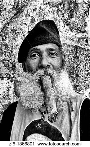 Stock Image - Old Havana Habana Cuba with man character with Che Tsirt and long huge cigar in costume and portrait. Fotosearch