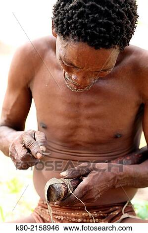 Old Jo/? hoansi San man working on a quiver for arrows, Namibia, Africa. View Large Photo Image Stock Photograph - Old Jo/? hoansi San man working on a quiver for arrows, Namibia, Africa.. Fotosearch