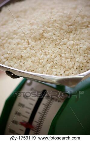 Stock Photo - Old kitchen scale with rice. Fotosearch