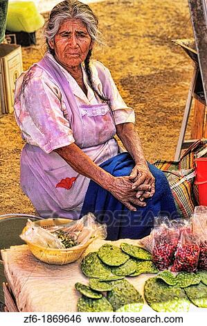 Stock Photograph - Old lady in Cactus Market selling plants in San Miguel Mexico. Fotosearch