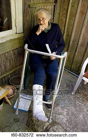 Old lady sitting in a chair outside and her leg is in a cast (plaster) View Large Photo Image Stock Image - Old lady sitting in a chair outside and her leg is in a cast (plaster). Fotosearch