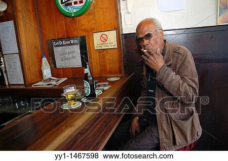 Old man drinking a beer at a bar down town Rotterdam. View Large Photo Image Stock Photo - Old man drinking a beer at a bar down town Rotterdam.. Fotosearch