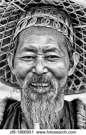 Old man fisherman portrait smoking in traditional costume in Yangshuo China View Large Photo Image Stock Image - Old man fisherman portrait smoking in traditional costume in Yangshuo China. Fotosearch