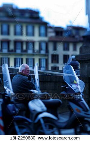 Old man in a motocicle, Florence - Italy. View Large Photo Image Stock Image - Old man in a motocicle, Florence - Italy.. Fotosearch