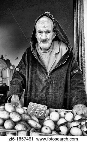 Stock Image - Old man selling oranges in Testour in Tunisia Africa. Fotosearch