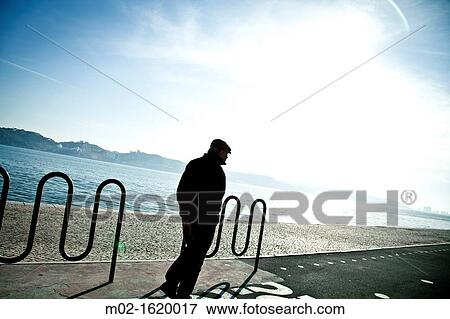 Old man walking at the riverside of Lisbon, Portugal, Europe View Large Photo Image Stock Photo - Old man walking at the riverside of Lisbon, Portugal, Europe. Fotosearch