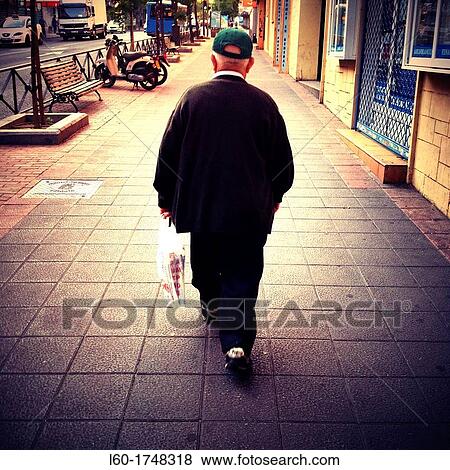 Old man walking in Vallecas, Madrid, Spain View Large Photo Image Stock Photo - Old man walking in Vallecas, Madrid, Spain. Fotosearch