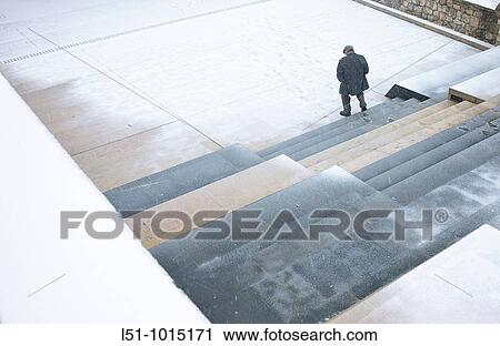 Old man walking under a snowfall on a park in Morella View Large Photo Image Stock Image - Old man walking under a snowfall on a park in Morella. Fotosearch