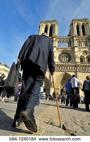Old man with cane in front of Notre-Dame Cathedral.? le de la Cit?. Paris, France. View Large Photo Image Picture - Old man with cane in front of Notre-Dame Cathedral.? le de la Cit?. Paris, France.. Fotosearch