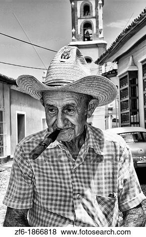 Old man with cigar on cobblestone scene with old car in street scene with old church of the old colonial city of Trinidad in Cuba View Large Photo Image Stock Photo - Old man with cigar on cobblestone scene with old car in street scene with old church of the old colonial city of Trinidad in Cuba. Fotosearch