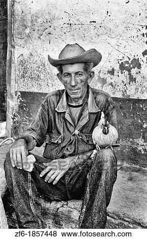 Old man with his chicken on streets of old village of Trinidad Cuba View Large Photo Image Stock Photo - Old man with his chicken on streets of old village of Trinidad Cuba. Fotosearch