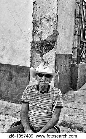 Old man with rooster on head in old Colonial village of Trinidad Cuba View Large Photo Image Stock Photo - Old man with rooster on head in old Colonial village of Trinidad Cuba. Fotosearch