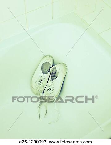Old plimsolls in a bath View Large Photo Image Stock Photo - Old plimsolls in a bath. Fotosearch