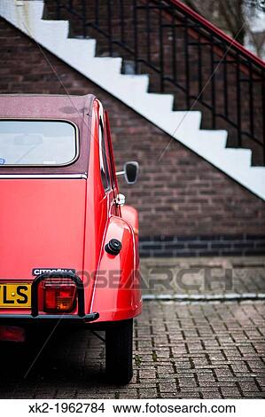 Old red citroen car parked in front of the stair house View Large Photo Image Picture - Old red citroen car parked in front of the stair house. Fotosearch
