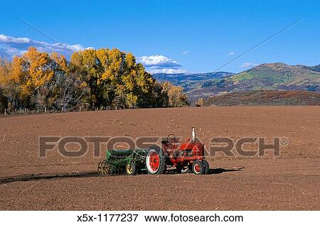 Old red tractor in plowed field near Steamboat Springs, Colorado, USA View Large Photo Image Stock Photo - Old red tractor in plowed field near Steamboat Springs, Colorado, USA. Fotosearch