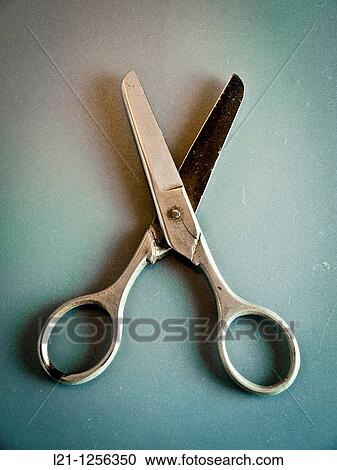 Stock Image - Old scissors on a grey background. Fotosearch
