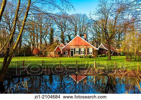 Picture - old small farmhouse with pool in the Achterhoek, the Netherlands. Fotosearch